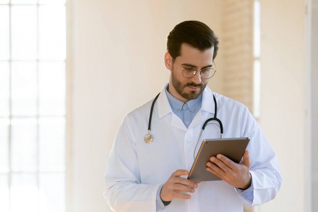 A clinician looks at a HIPAA-compliant intranet on a tablet